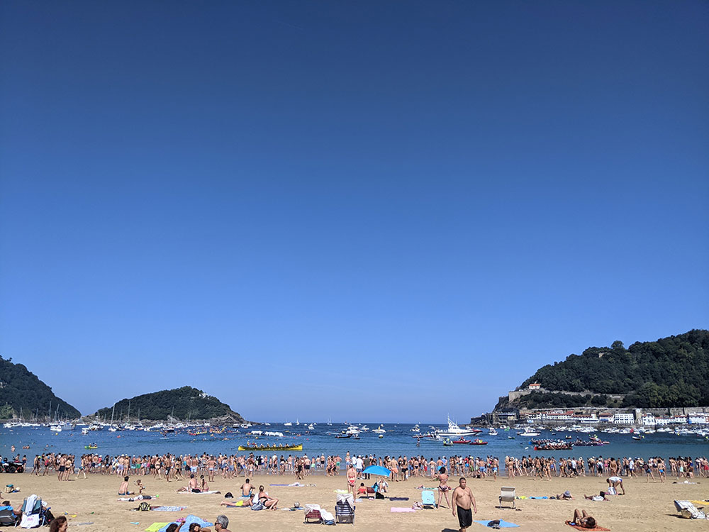 people sunbathing on la concha beach in san sebastian