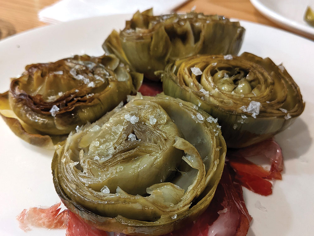 A close up of artichokes with jamon servered at Itsaspe in San Sebastian 