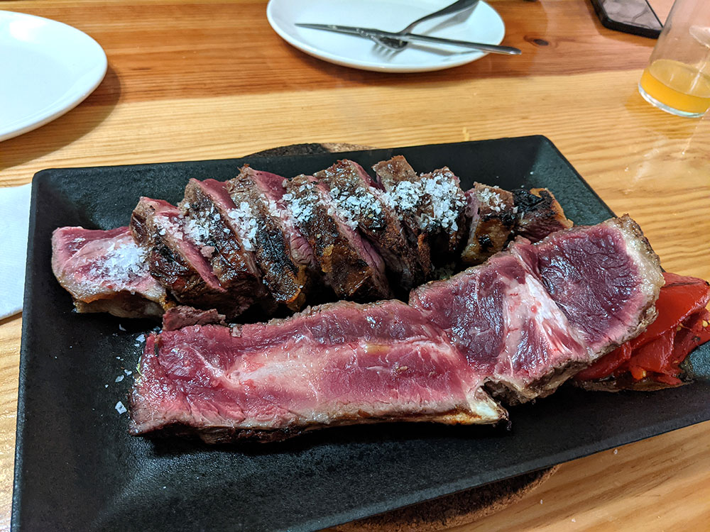 traditional basque txuleta steak served in the middle of a table