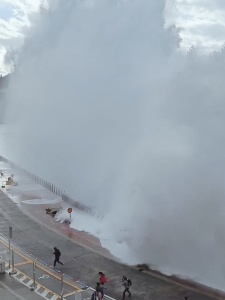 Huge wave reaching over the wall on Paseo Nuevo in San Sebastian